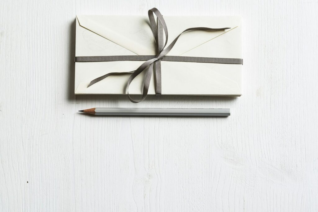 A gift certificate wrapped up in an envelope and bow.
